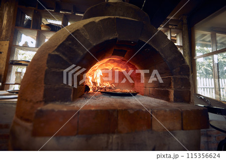 pizza traditional  oven in open kitchen 115356624