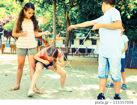Children games. Girl goes through the tangled rope 115357056