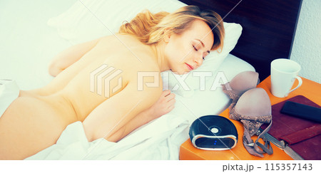 Girl sleeping not covered on bed Girl sleeping not covered on bed 115357143