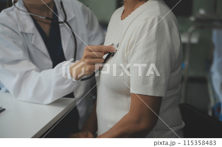 Doctor using sphygmomanometer with stethoscope checking blood pressure to a patient in the hospital. 115358483