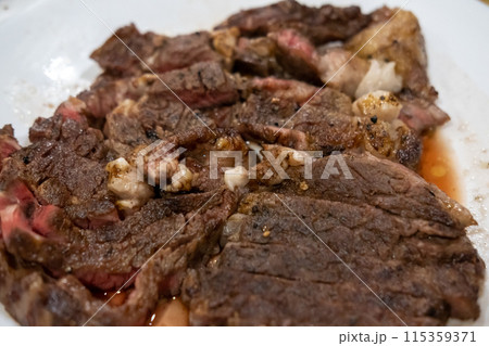 Medium rare sliced sirloin meat on the white cutting board 115359371