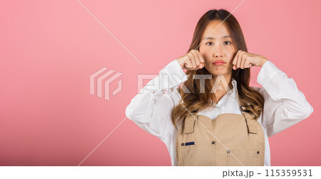 Unhappy small business woman bad mood her cry wipe tears with fingers, Asian beautiful young female stress feeling sad unhappy crying, studio shot isolated on pink background with copy space Unhappy small business woman bad mood her cry wipe tears with fingers, Asian beautiful young female stress feeling sad unhappy crying, studio shot isolated on pink background with copy space 115359531
