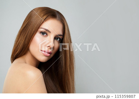 Posing woman with long hair and fresh clean skin studio portrait on grey background. Posing woman with long hair and fresh clean skin studio portrait on grey background. 115359807