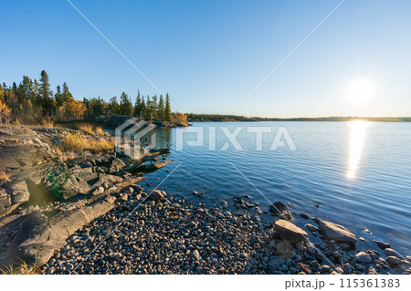 Frame Lake shore at sunset time, clear sky and sunlight. Yellowknife, Canada. 115361383