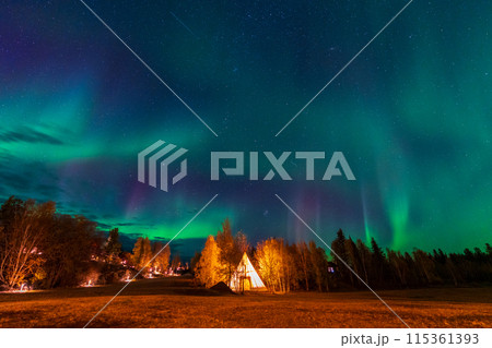 Amazing northern lights dancing over the light up Tipi or Tepees at Aurora Village in Yellowknife, Northwest Territories, Canada. Amazing northern lights dancing over the light up Tipi or Tepees at Aurora Village in Yellowknife, Northwest Territories, Canada. 115361393