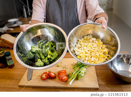 Chef at the kitchen preparing tofu scramble with vegetables 115361513