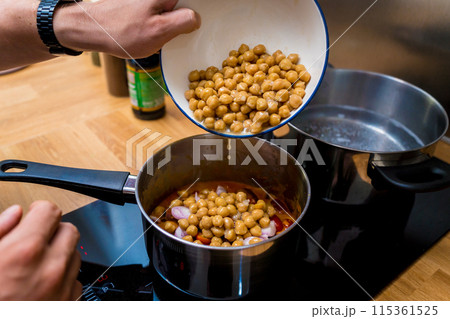 Chef at the kitchen preparing massaman curry with sweet potato and many spices Chef at the kitchen preparing massaman curry with sweet potato and many spices 115361525