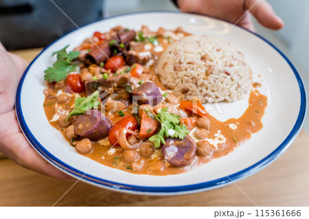 A vegetarian massaman curry in a bowl with sweet potato and many spices 115361666