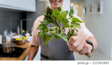 Chef at the kitchen preparing green curry with herbs and rice 115361667