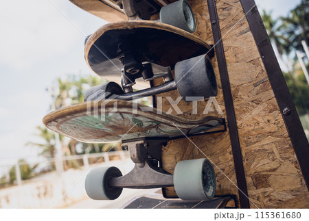 A stack of skateboards on a special outdoor stand 115361680