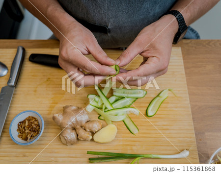 Chef at the kitchen preparing rice porridge with onion and sesame seeds 115361868