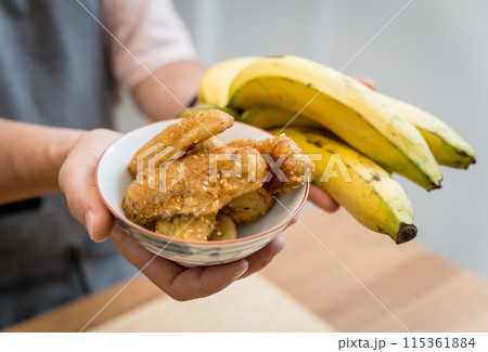 Crispy fried bananas in the small white bowl 115361884