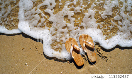 a pair of flip-flops, abandoned on a sandy beach  115362487