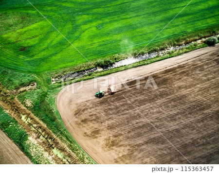 harvester plowing field in spring harvester plowing field in spring 115363457
