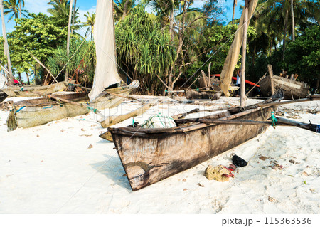Rustic boats with masts on sandy beach Rustic boats with masts on sandy beach 115363536