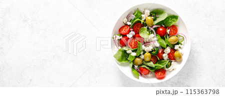 Fresh healthy vegetable Mediterranean salad of feta cheese, tomato, olives, green pepper and green basil leaves, banner, top view Fresh healthy vegetable Mediterranean salad of feta cheese, tomato, olives, green pepper and green basil leaves, banner, top view 115363798