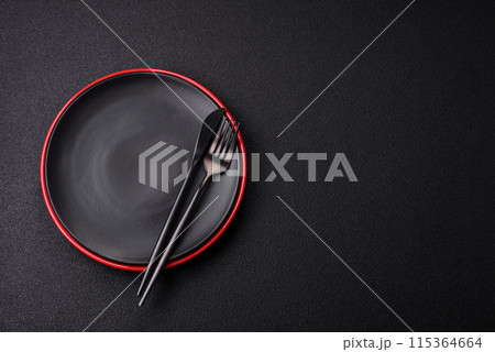 Empty ceramic round plate on dark textured concrete background Empty ceramic round plate on dark textured concrete background 115364664