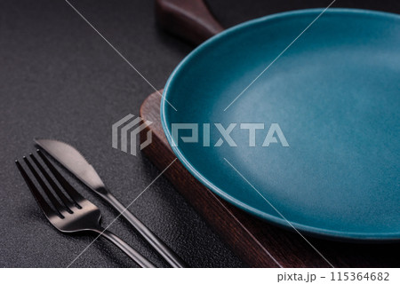 Empty ceramic round plate on dark textured concrete background 115364682
