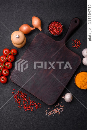 Empty wooden cutting board with spices, salt and herbs Empty wooden cutting board with spices, salt and herbs 115364750