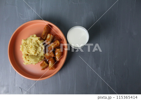 delicious lunch mashed potatoes sausages sausages glass of milk on a gray background with space for text copyspace top view 115365414