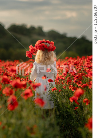 A young girl stands in a field of red poppies. She is wearing a white dress and a red flower crown. The scene is serene and peaceful, with the girl surrounded by the beauty of nature. A young girl stands in a field of red poppies. She is wearing a white dress and a red flower crown. The scene is serene and peaceful, with the girl surrounded by the beauty of nature. 115366207