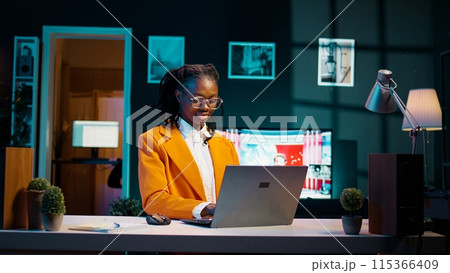 Dedicated student doing school research analyzing case studies or real scenarios relevant to coursework, creative education. Young woman preparing materials for future online lessons. Camera B. 115366409