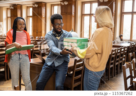 Group of young people in the library looking busy and involved 115367262