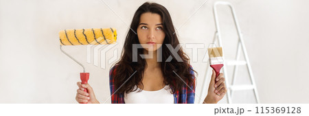 Pensive Woman Holding Paint Supplies for DIY Home Renovation Banner 115369128