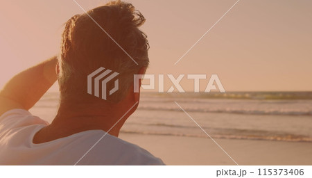 Rear view of caucasian senior man enjoying the view at the beach 115373406