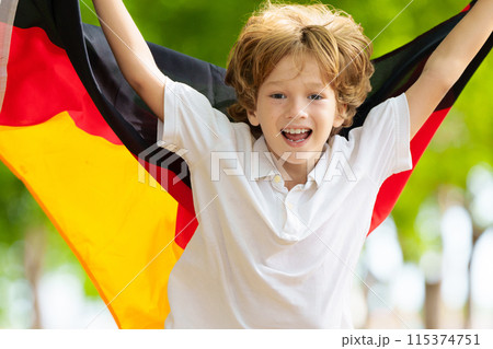 Child running with Germany flag. 115374751
