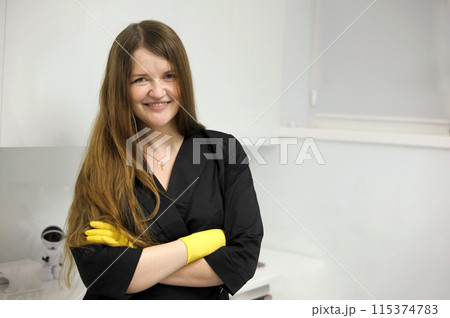 beautiful young woman in yellow latex gloves with flowing hair and in a black bathrobe on Woman wearing latex gloves isolated on light copy space background. Professional culinary. Master class. beautiful young woman in yellow latex gloves with flowing hair and in a black bathrobe on Woman wearing latex gloves isolated on light copy space background. Professional culinary. Master class. 115374783
