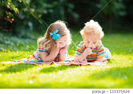 Kids play outdoor in sunny summer garden Kids play outdoor in sunny summer garden 115375026