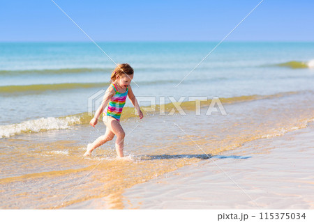 Kids playing on beach. Children play at sea. 115375034