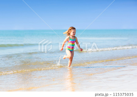 Kids playing on beach. Children play at sea. 115375035