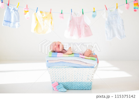 Newborn baby in a basket with towels Newborn baby in a basket with towels 115375142