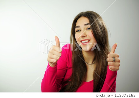 sincere laugh beautiful white teeth long hair Insanely beautiful girl advertises something on white background, she turns and points to the side with her fingers, then shows her thumb into the frame 115375165