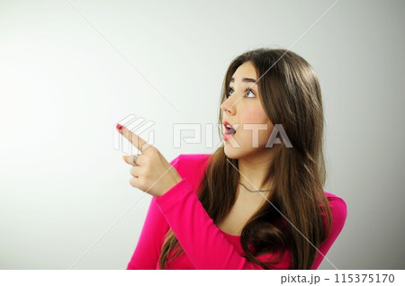 Place for text advertising sales Insanely beautiful young woman girl with long brown hair in a pink sweater on a white background different emotions Many positive emotions joy happiness fun success Place for text advertising sales Insanely beautiful young woman girl with long brown hair in a pink sweater on a white background different emotions Many positive emotions joy happiness fun success 115375170