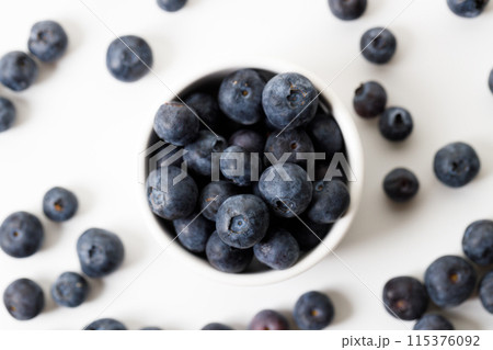 Ripe organic blueberries on white wooden table background. Selective focus. Ripe organic blueberries on white wooden table background. Selective focus. 115376092