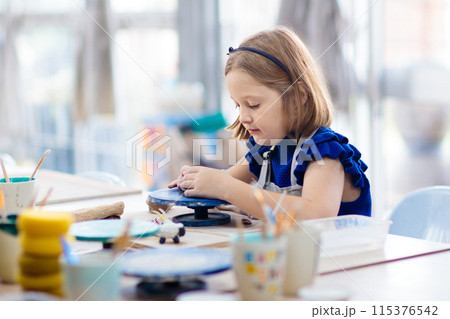 Child at pottery wheel. Kids arts and crafts class Child at pottery wheel. Kids arts and crafts class 115376542