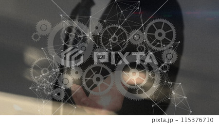 Image of network of connections with cogs over caucasian businessman 115376710