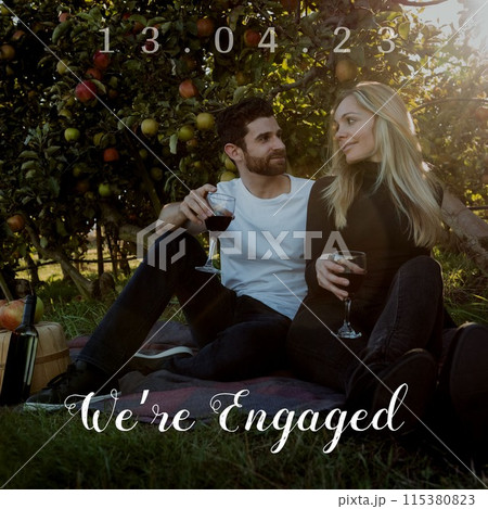 Celebrating love, a couple shares a romantic moment in an orchard, symbolizing engagement and compan 115380823