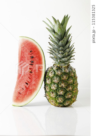 Fresh red watermelon and ripe pineapple on white background. Fresh red watermelon and ripe pineapple on white background. 115381325