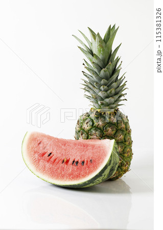 Fresh red watermelon and ripe pineapple on white background. Fresh red watermelon and ripe pineapple on white background. 115381326
