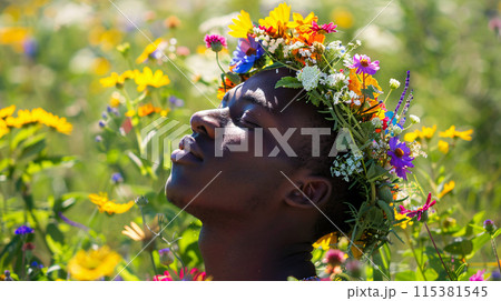 male model wearing a flower crown, surrounded by a field of wildflowers male model wearing a flower crown, surrounded by a field of wildflowers 115381545