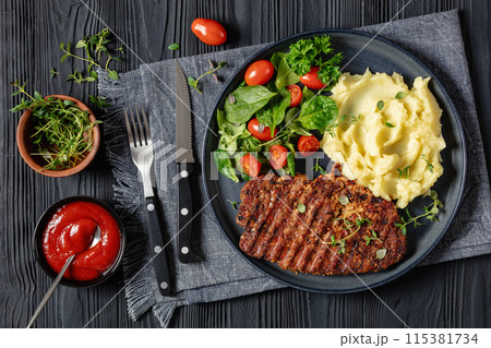 grilled pork steak with mashed potato and salad 115381734