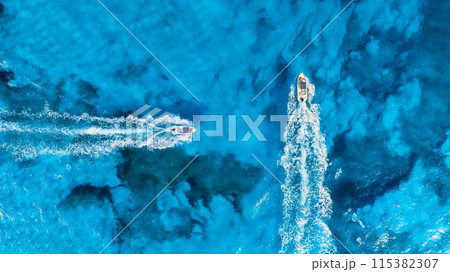 Vacation and leisure. Aerial view on fast boats on blue sea at sunny day. Vacation and leisure. Aerial view on fast boats on blue sea at sunny day. 115382307