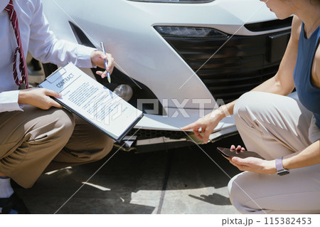 Insurance concept, insurance agent checking broken car and submit a claim form after an accident traffic accident. Insurance concept, insurance agent checking broken car and submit a claim form after an accident traffic accident. 115382453