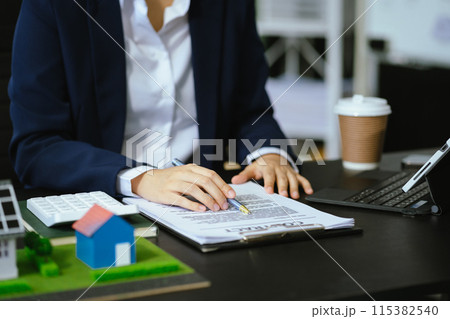 Real estate broker agent presenting and consult to customer to decision making sign insurance form agreement, home model, concerning mortgage loan offer in office Real estate broker agent presenting and consult to customer to decision making sign insurance form agreement, home model, concerning mortgage loan offer in office 115382540