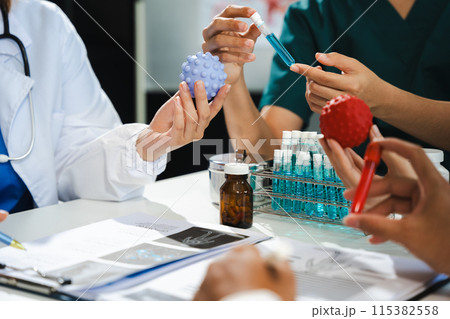 Medical team students discussing over blood sample in the room. Medical team students discussing over blood sample in the room. 115382558