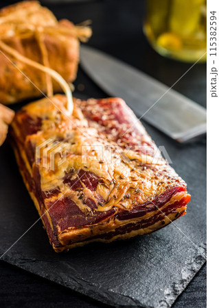 Smoked and Cured Pork Belly With Caraway Seeds on Cutting Board. Smoked and Cured Pork Belly With Caraway Seeds on Cutting Board. 115382594
